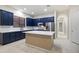 Modern kitchen with island, stainless steel appliances, and stylish blue cabinetry at 3551 W Hidden Mountain Ln, Anthem, AZ 85086