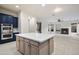 Bright, open kitchen with a spacious island, modern appliances, and stylish blue cabinets at 3551 W Hidden Mountain Ln, Anthem, AZ 85086