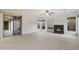 Cozy living room featuring tile flooring, large windows, and a modern fireplace at 3551 W Hidden Mountain Ln, Anthem, AZ 85086