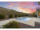 View of a private pool with desert landscaping and a beautiful sunset backdrop, providing a tranquil retreat at 3551 W Hidden Mountain Ln, Anthem, AZ 85086