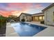 A backyard view featuring a sparkling pool with water fountains, and an outdoor kitchen at 3551 W Hidden Mountain Ln, Anthem, AZ 85086