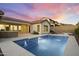 An outdoor view featuring a sparkling pool with water fountains, surrounded by a concrete patio at 3551 W Hidden Mountain Ln, Anthem, AZ 85086