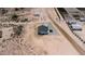 Wide overhead shot of new home surrounded by desert landscape and a rock driveway at 3887 S 331St Ave, Tonopah, AZ 85354