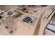 New construction home surrounded by native desert growth with rock landscaping at 3887 S 331St Ave, Tonopah, AZ 85354