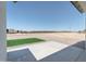 Expansive backyard featuring a concrete patio, artificial turf, and gravel, perfect for outdoor living at 3887 S 331St Ave, Tonopah, AZ 85354