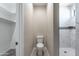 Bright bathroom featuring a toilet, walk-in shower with marble tiling, and a small window for natural light at 3887 S 331St Ave, Tonopah, AZ 85354