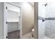Bathroom showcasing marble tiled walk-in shower, toilet and doorway to walk in closet space at 3887 S 331St Ave, Tonopah, AZ 85354