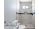 Bathroom with a walk-in shower featuring marble tiling, a toilet, and a granite-topped vanity at 3887 S 331St Ave, Tonopah, AZ 85354