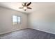 Bedroom with carpet floors, ceiling fan, and window with a view at 3887 S 331St Ave, Tonopah, AZ 85354