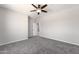 Bedroom with carpet floors, ceiling fan, and view into hallway at 3887 S 331St Ave, Tonopah, AZ 85354