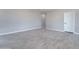 A bedroom features neutral-toned walls, light grey wood-look tile flooring, and a white door at 3887 S 331St Ave, Tonopah, AZ 85354