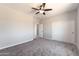 Bedroom featuring carpet floors, ceiling fan, and access to a bathroom at 3887 S 331St Ave, Tonopah, AZ 85354