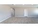 A bedroom offers neutral-toned walls, light grey wood-look tile flooring, and a white door at 3887 S 331St Ave, Tonopah, AZ 85354