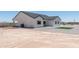 Rear exterior view of a modern home with low-maintenance yard and potential for desert landscaping at 3887 S 331St Ave, Tonopah, AZ 85354