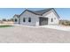 Charming single-Gathering home with a gray garage door, artificial turf, and low-maintenance yard at 3887 S 331St Ave, Tonopah, AZ 85354