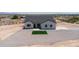 Modern home with a xeriscaped yard and a touch of green with a square of turf situated in a serene desert setting at 3887 S 331St Ave, Tonopah, AZ 85354