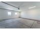 Spacious garage with concrete floors, white walls, bright lighting, and two windows at 3887 S 331St Ave, Tonopah, AZ 85354