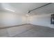 Clean and spacious garage with concrete floors, bright lighting, and a utility door at 3887 S 331St Ave, Tonopah, AZ 85354