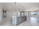 Kitchen features a gray center island and stainless steel appliances at 3887 S 331St Ave, Tonopah, AZ 85354