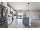 Kitchen boasts stainless steel appliances, granite counters, and gray island at 3887 S 331St Ave, Tonopah, AZ 85354