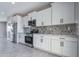 Kitchen with stainless steel appliances, white cabinets, and granite countertops at 3887 S 331St Ave, Tonopah, AZ 85354