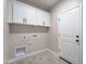 The laundry room features overhead cabinets for storage and a utility sink connection at 3887 S 331St Ave, Tonopah, AZ 85354