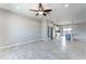 Open-concept living area boasts a ceiling fan, and flows into a modern kitchen and pantry at 3887 S 331St Ave, Tonopah, AZ 85354