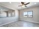 Living room with wood-look tile flooring, granite breakfast bar and natural light at 3887 S 331St Ave, Tonopah, AZ 85354