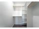 Walk-in closet with white shelving and carpet floors at 3887 S 331St Ave, Tonopah, AZ 85354