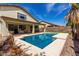 A backyard pool features a covered patio with plenty of seating, perfect for relaxing and entertaining at 4245 E Shannon St, Gilbert, AZ 85295