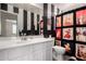 Bathroom with striped walls, white vanity, and a shower with vintage-themed curtain at 4245 E Shannon St, Gilbert, AZ 85295