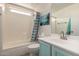 Bright bathroom featuring a shower-tub combo, ample lighting, and blue-accented vanity at 4245 E Shannon St, Gilbert, AZ 85295