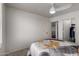 Bedroom features a ceiling fan, carpet, and white walls at 4245 E Shannon St, Gilbert, AZ 85295