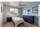 Cozy bedroom with blue accent wall, ceiling fan, and view to the outside at 4245 E Shannon St, Gilbert, AZ 85295