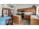 Bright kitchen with island, oak cabinets, tile countertops, and stainless steel appliances at 4245 E Shannon St, Gilbert, AZ 85295