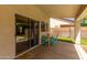 Covered patio with table and chairs, offering an outdoor seating area and backyard access at 4245 E Shannon St, Gilbert, AZ 85295