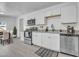 Modern kitchen with stainless steel appliances, white cabinets, and hardwood flooring at 437 W 6Th Pl, Mesa, AZ 85201