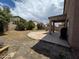 A spacious backyard featuring a patio area and a well-sized lawn, perfect for outdoor activities at 44328 W Knauss Dr, Maricopa, AZ 85138