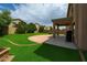 Lush backyard featuring a spacious patio area perfect for outdoor entertaining and relaxation at 44328 W Knauss Dr, Maricopa, AZ 85138