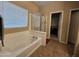 Bathroom featuring a jacuzzi and a sliding door shower at 44328 W Knauss Dr, Maricopa, AZ 85138