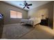 Bedroom featuring a ceiling fan and a large window at 44328 W Knauss Dr, Maricopa, AZ 85138