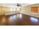 Bright bonus room features wood floors, neutral walls, a ceiling fan and windows for plenty of natural light at 44328 W Knauss Dr, Maricopa, AZ 85138
