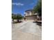 Beautiful home featuring a large driveway and well-manicured trees in the front yard at 44328 W Knauss Dr, Maricopa, AZ 85138