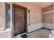 Inviting front entrance with a solid wood door and decorative sidelights at 44328 W Knauss Dr, Maricopa, AZ 85138