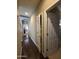 Hallway with wood flooring and white doors, creating a clean and inviting transition at 44328 W Knauss Dr, Maricopa, AZ 85138