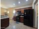 Bright kitchen with stainless steel appliances, tile floors, and warm-toned cabinetry at 44328 W Knauss Dr, Maricopa, AZ 85138