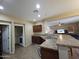 Well-appointed kitchen with modern appliances and a breakfast bar overlooking the living area at 44328 W Knauss Dr, Maricopa, AZ 85138