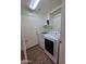 Laundry room with modern washer and dryer, plus storage shelves and access to the outside at 44328 W Knauss Dr, Maricopa, AZ 85138