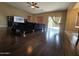 Open living room showcasing wood flooring and a sliding glass door to the backyard at 44328 W Knauss Dr, Maricopa, AZ 85138