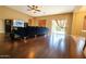 Spacious living room boasts wood floors, neutral walls, and sliding glass doors to the backyard at 44328 W Knauss Dr, Maricopa, AZ 85138